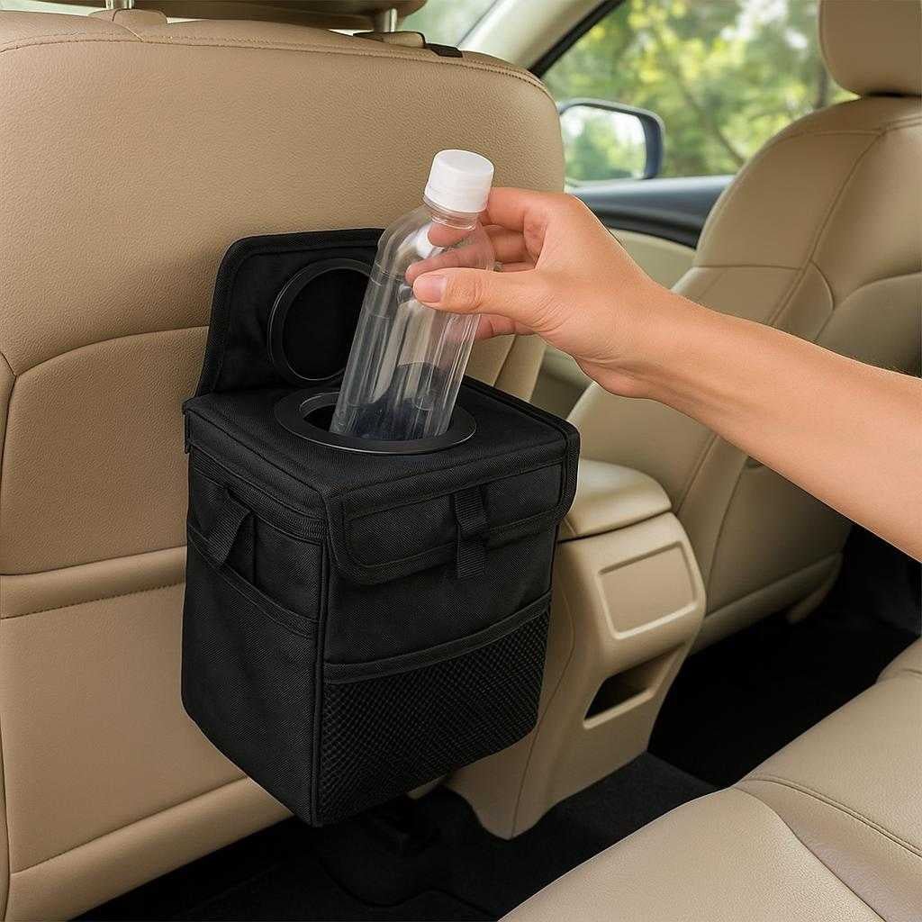 bilskraldespand-i-moderne-design-vandtt-og-rumme_15205077614979_scene1 Bilskraldespand i moderne design - Vandtæt og rummelig med nem montering: A realistic car interior setting where the bilskraldespand is properly grounded on the backseat organizer, being actively used by a visible hand placing a plastic bottle inside.