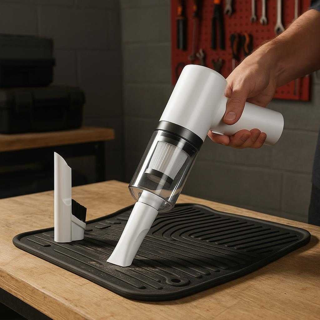 bilstvsuger-ledningsfri-kompakt-og-effektiv-til_15061920973187_scene2 Bilstøvsuger Ledningsfri - Kompakt og Effektiv til Bilrengøring, Høj Kvalitet: A different realistic home garage setting where the product is securely positioned on a sturdy workbench, being used to clean dust from a car floor mat, with proper physics, shadows, and realistic integration into the environment.