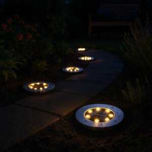 Solcellelamper til Haven: 4-pak Jordspyd med LED & Automatisk Opladning - Tilgængelig i Hvid og Varm Hvid: A realistic evening garden setting where the solar lights are properly grounded in a garden path, illuminating the walkway with a warm glow.